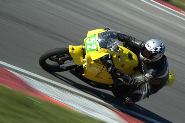 Yellow Aprilia Rs125 Motorbike On A Racing Track
