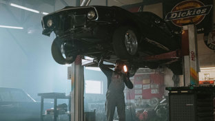 A classic car on a ramp in a garage