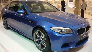 Blue BMW M5 F10 in a showroom 