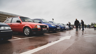 Classic cars lined up in the rain