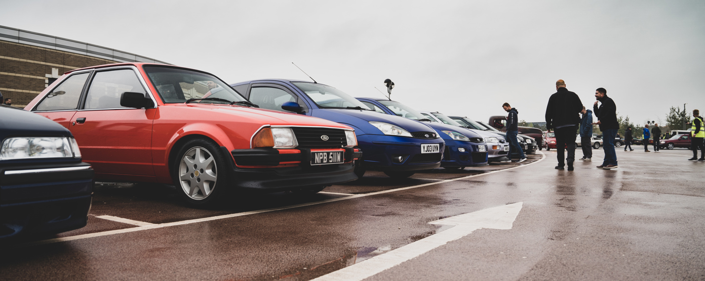 Classic cars lined up in the rain