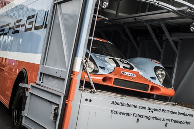 light-blue-and-orange-number-19-porsche-917k-racing-carrying-a-cage-in-the-back-of-a-truck