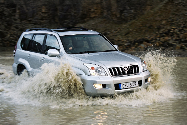 Silver 2003 to 2009 Toyota Land Cruiser 120 Series driving through water