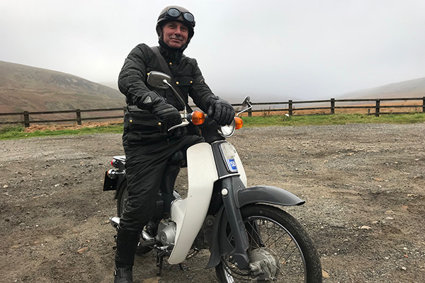 Header Mark Gibson riding his Honda C65 Super Cub