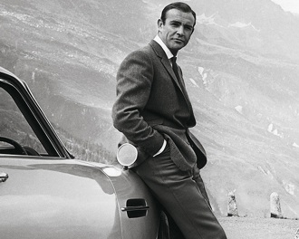 James Bond leans against a car in Goldfinger