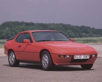 A red Porsche 924 parked on a race track