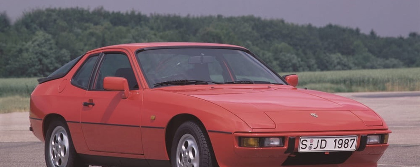 A red Porsche 924 parked on a race track
