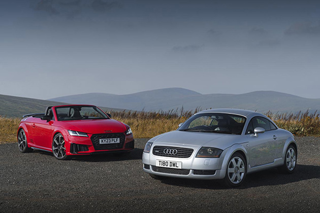 a-red-and-a-silver-audi-tt-with-green-mountainous-backdrop