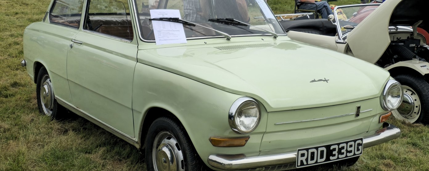A pea green DAF at a classic car show