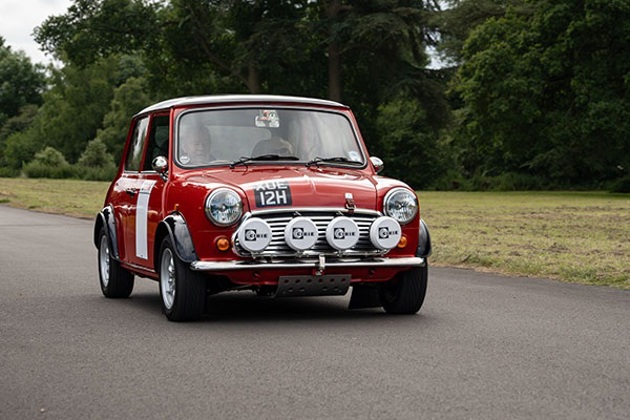 A red Mini on a country lane