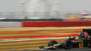 header-lotus-761-john-player-special-formula-1-racing-car-on-a-track-blurred-back-drop-of-a-ferris-wheel-and-helter-skelter