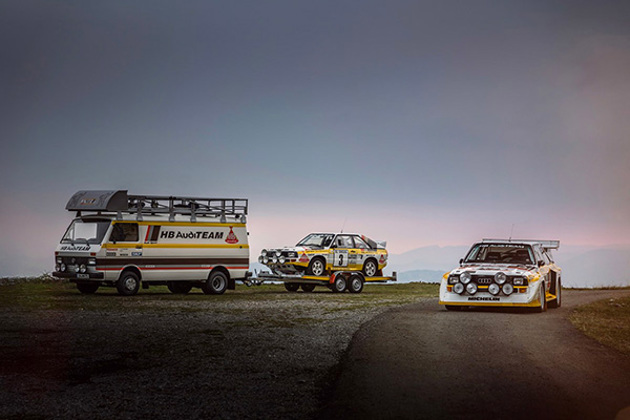 1985-ixo-volkswagen-lt45-swb-hb-audi-team-rally-assistance-van-carrying-a-audi-sport-quattro-rally-car-on-grass-and-gravel-beside-another-on-tarmac