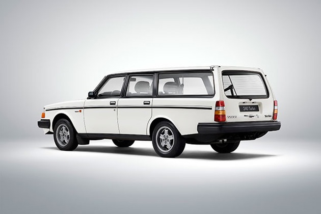 A white Volvo 240 with a grey background