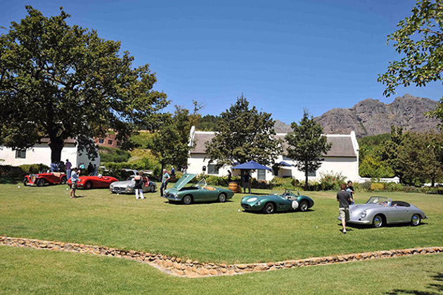 classic-racing-cars-lawn-white-washed-single-story-housing-mountains