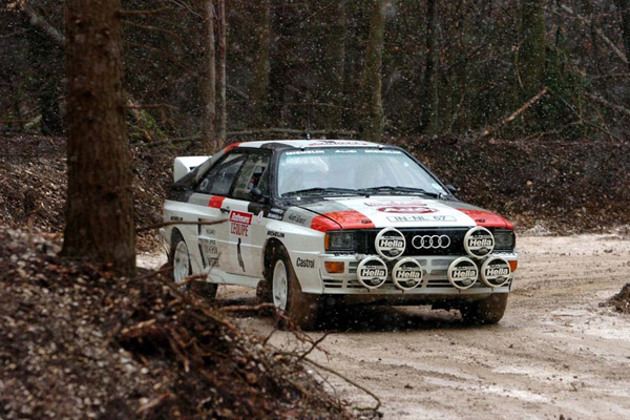 red-and-white-1980s-audi-quattro-driving-in-a-rallying