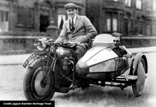 Men sat on motorcycle and sidecar
