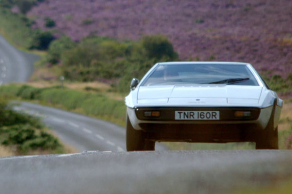 White 1977 Lotus Esprit S1 driving on a country road Courtesy The Classic Car Show